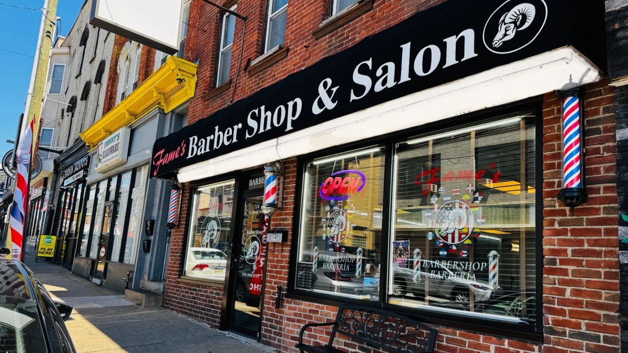 Street view of Fame's Barbershop at 114 N Main Ave, Scranton — storefront visible from across the street with surrounding businesses